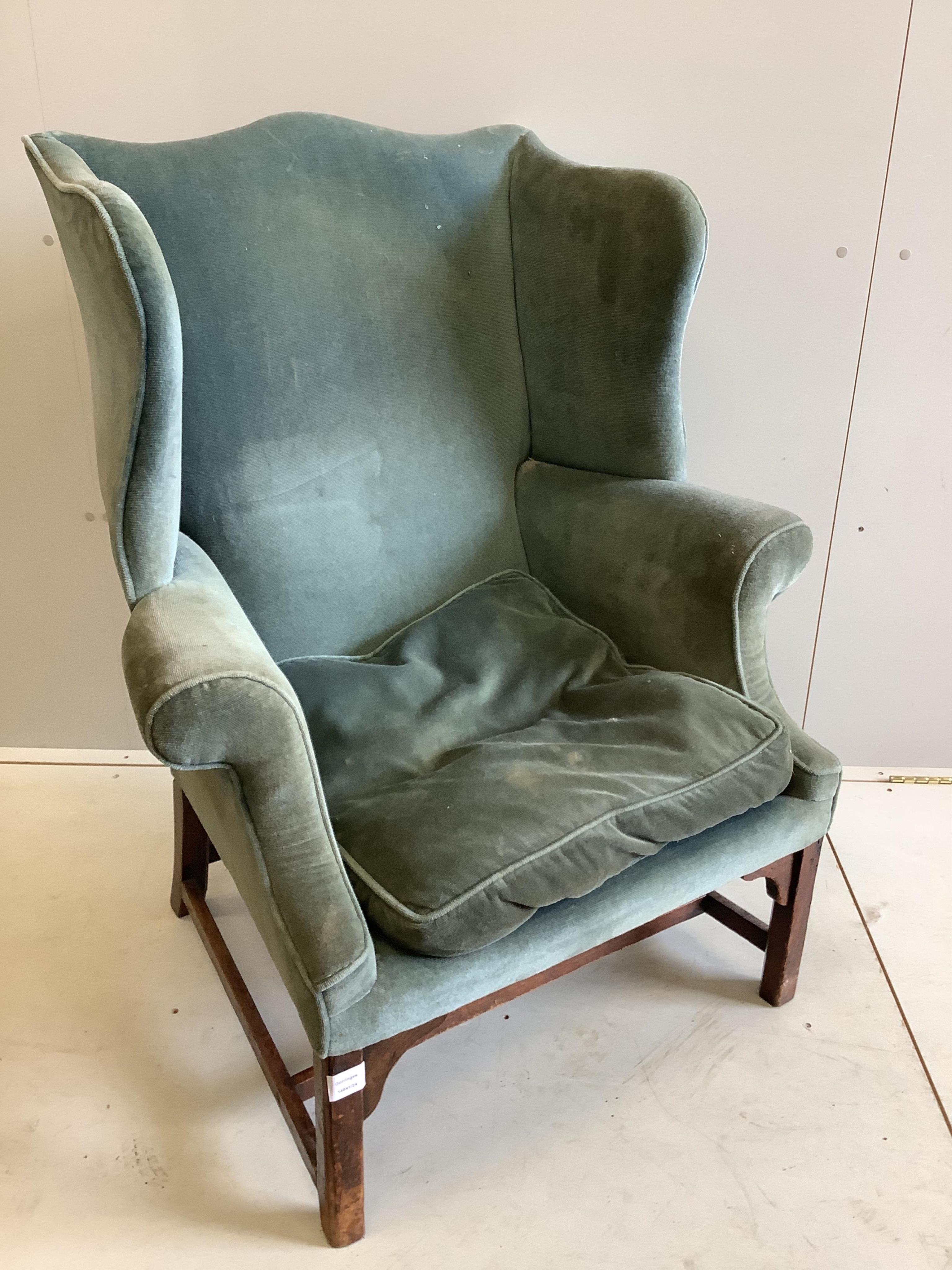 A George III upholstered wing back armchair, width 84cm, depth 64cm, height 105cm. Condition - fair